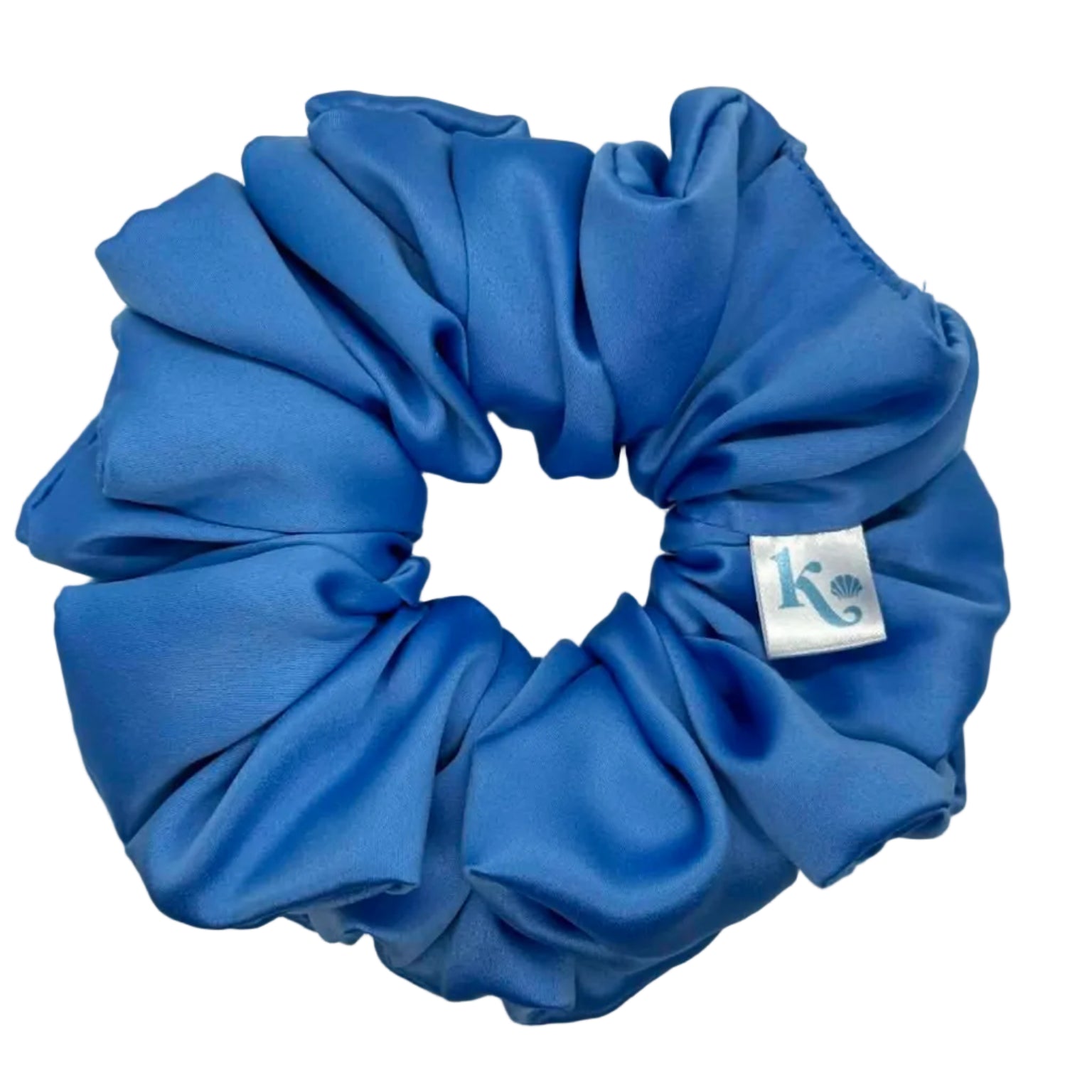 Blue scrunchie with a brand tag on a light gray background