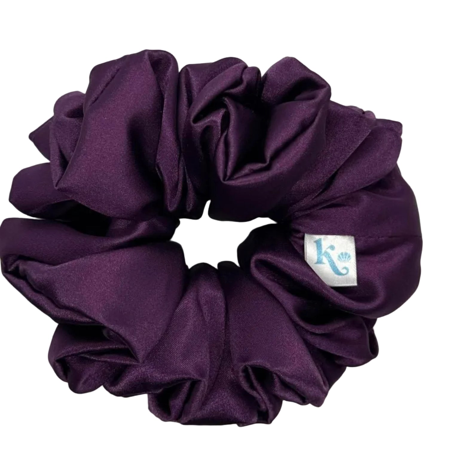 Purple scrunchie with a brand label on a light gray background